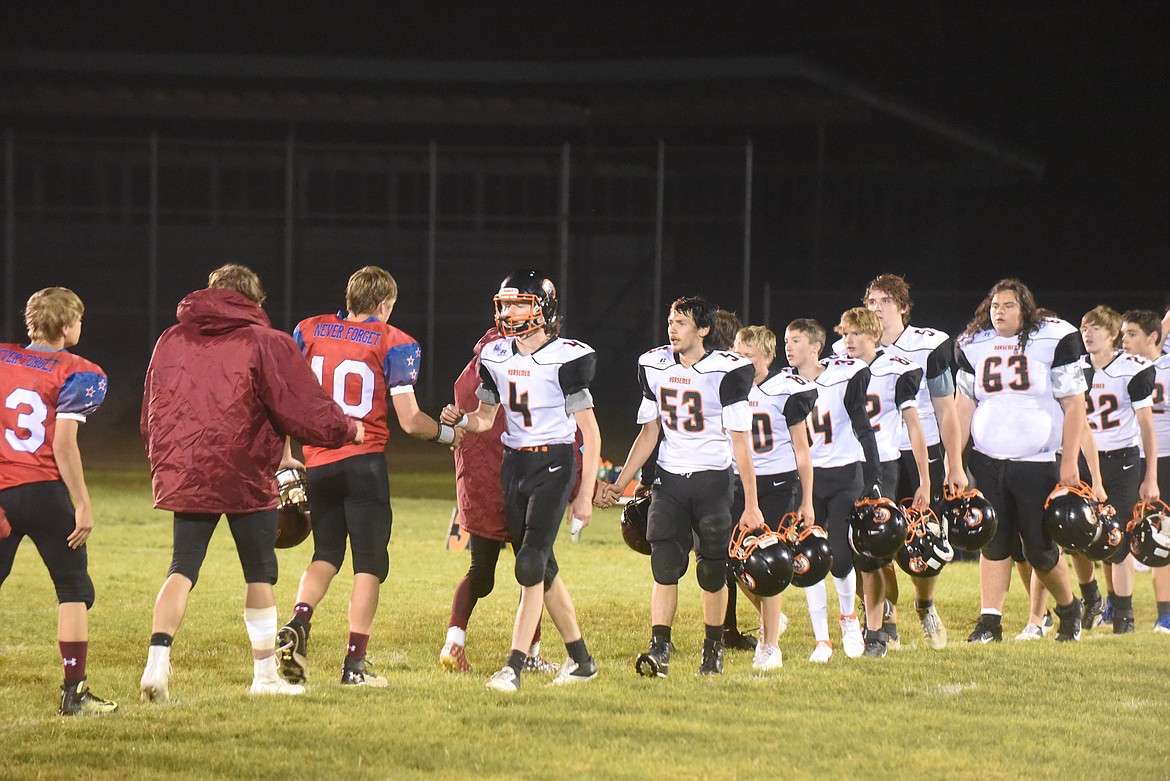 Plains Horsemen and Troy Trojans football players exchange post game hand shakes after last Thursday's contest. (Scott Shindledecker/Valley Press)