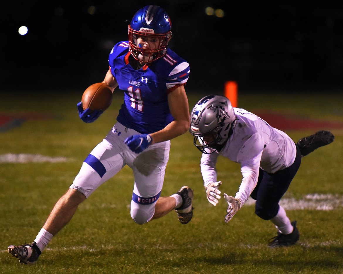 Vikings running back George Bucklin sprints past Anaconda defensive back Nathan Blodnick on his way to an 80-yard touchdown run in the second quarter in Bigfork on Friday. (Jeremy Weber/Daily Inter Lake)