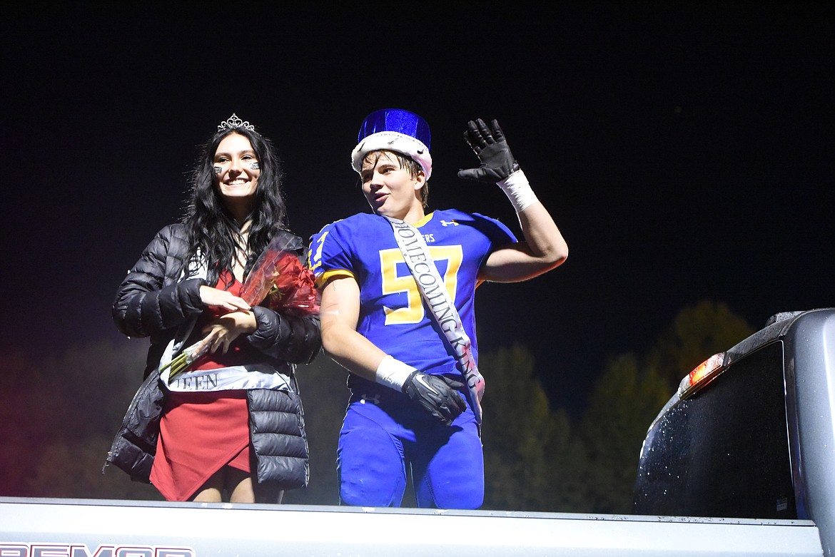 Arista Munsel and Zane Nordwick wave to the crowd from the bed of a Ford pickup after their coronation as Libby's 2021 homecoming king and queen. (Derrick Perkins/The Western News)