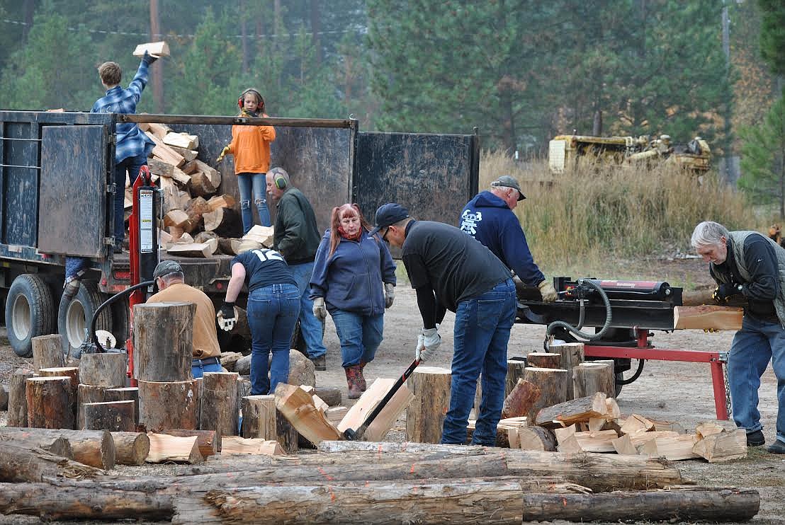 This firewood crew made quick work of hauling, cutting, splitting and stacking a winter's supply of wood heat for Lawana Hutchins on Saturday during this impromptu community gathering in St. Regis. (Amy Quinlivan/Mineral Independent)