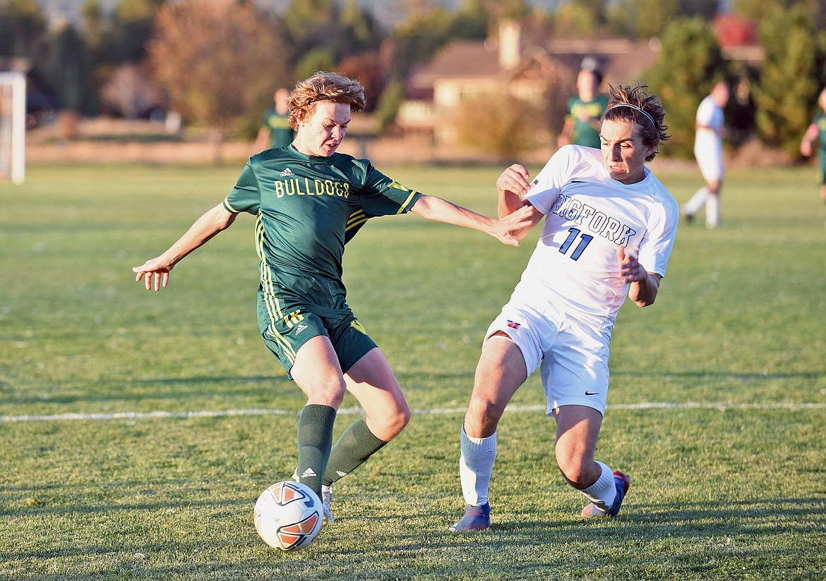 Whitefish sophomore Charlie Hyatt looks to take the ball past Bigfork defender Landon Byerman during a game in Whitefish on Thursday. (Whitney England/Whitefish Pilot)