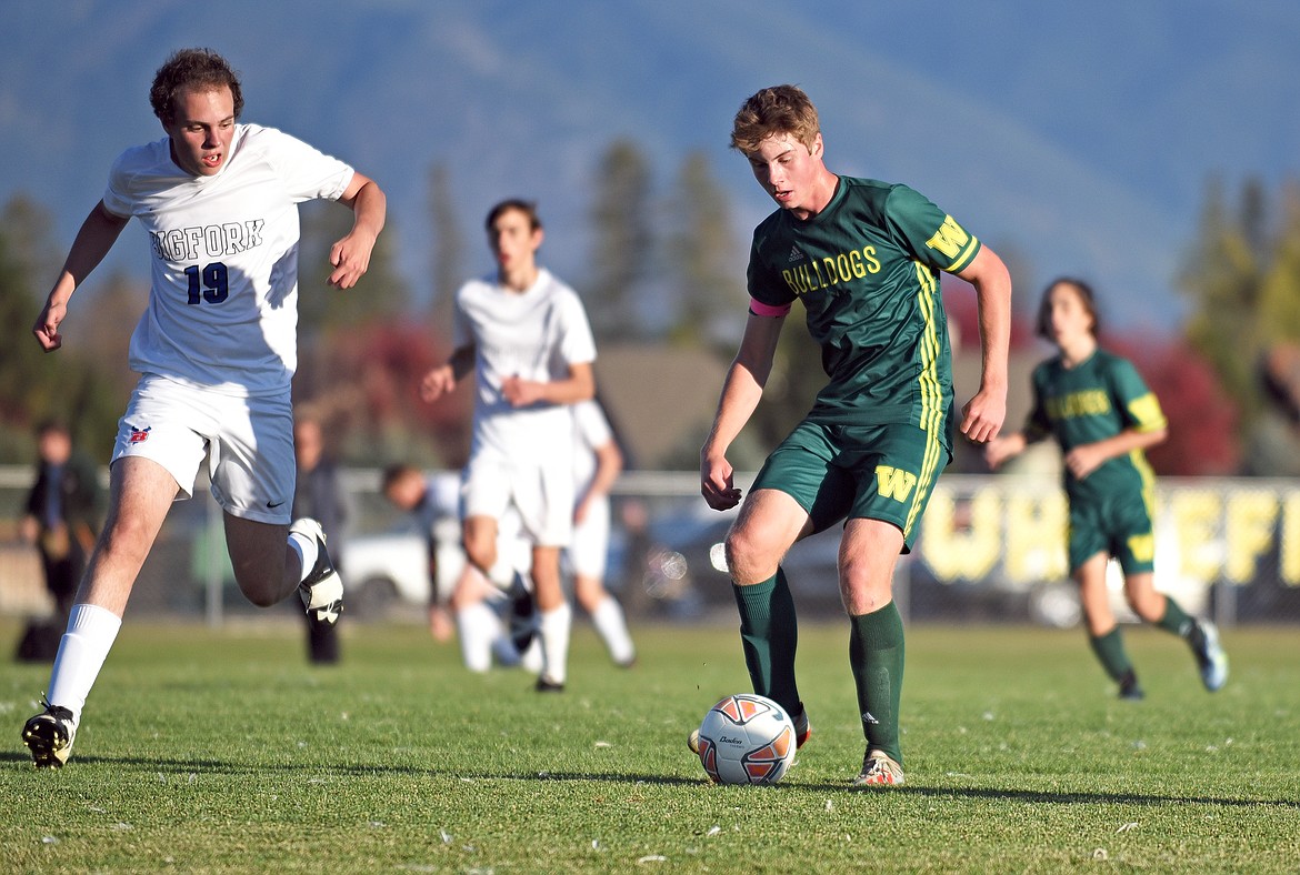 Whitefish senior midfielder Aaron Dicks looks to pass the ball during a game in Whitefish on Thursday. (Whitney England/Whitefish Pilot)