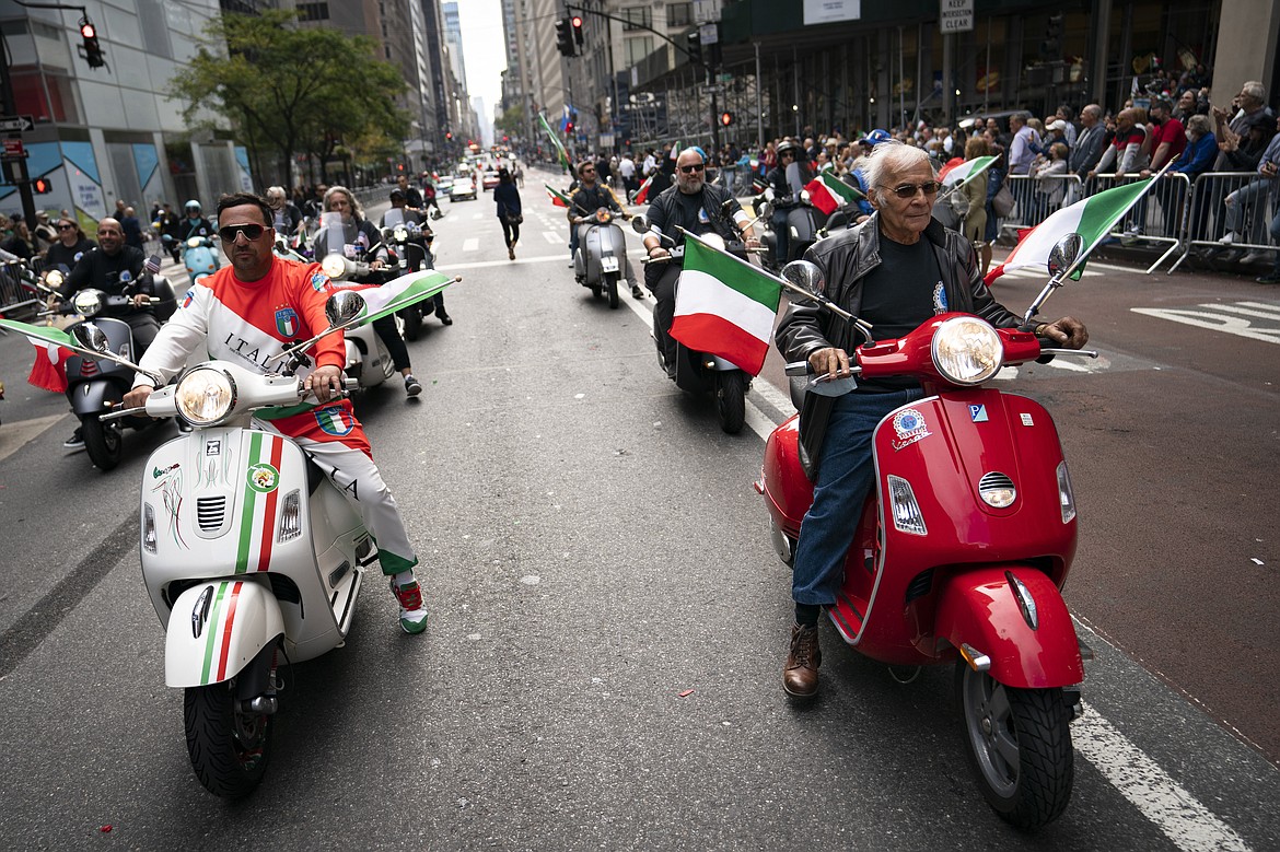 Motorists riding scooters with Italian flags roll up Fifth Avenue during the Columbus Day parade, Monday, Oct. 11, 2021, in the Manhattan borough of New York. (AP Photo/John Minchillo)