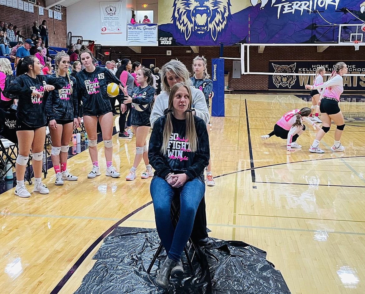 Kellogg High School Volleyball Coach Steph Batchelder gets her hair cut so she can donate it for the creation of a wig.