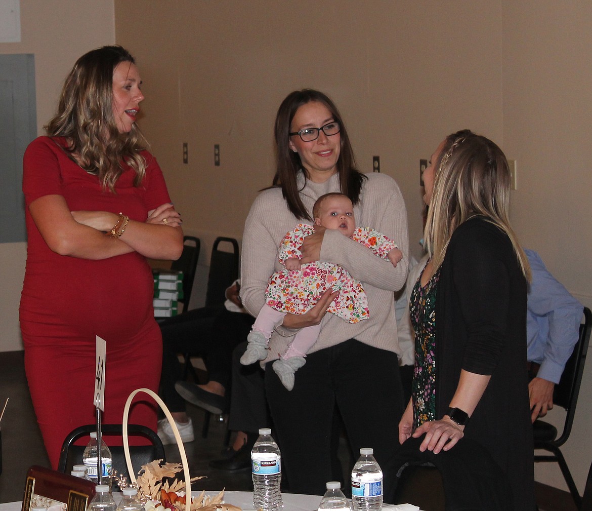 From left: Natalie Morrish, Jenna Norton and Mary Kottong visit before the Crossroads Pregnancy Resource Center banquet Saturday.