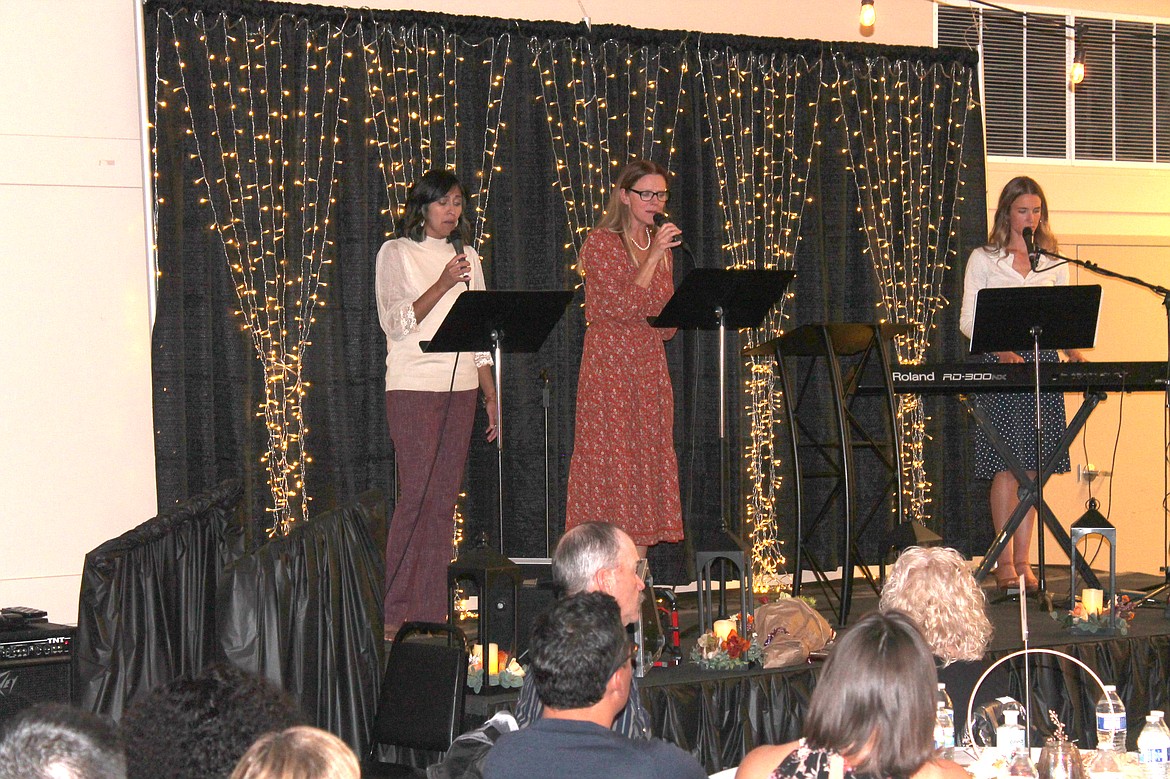 From left: Abby Martinez, Kirsten Hintz and Justine Friehe perform at the Crossroads Pregnancy Resource Center banquet Saturday.