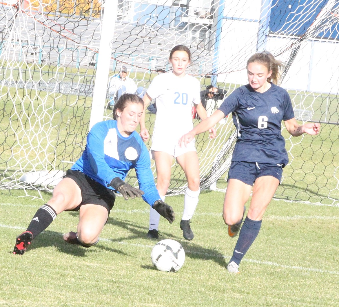 JASON ELLIOTT/Press
Coeur d'Alene junior goalkeeper Jay Ziegler dives on the ball for a save in front of Lake City junior defender Lucy Evans (6) and Coeur d'Alene junior forward Berkley Owens (20) during the 5A Region 1 girls soccer championship match on Tuesday.