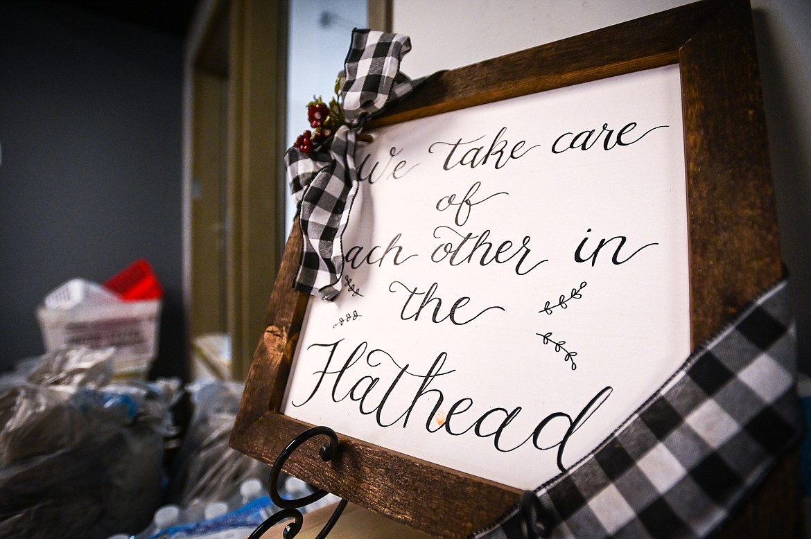 A decorative sign that reads "We take care of each other in the Flathead" at the Flathead Warming Center in Kalispell on Tuesday, Oct. 12. (Casey Kreider/Daily Inter Lake)