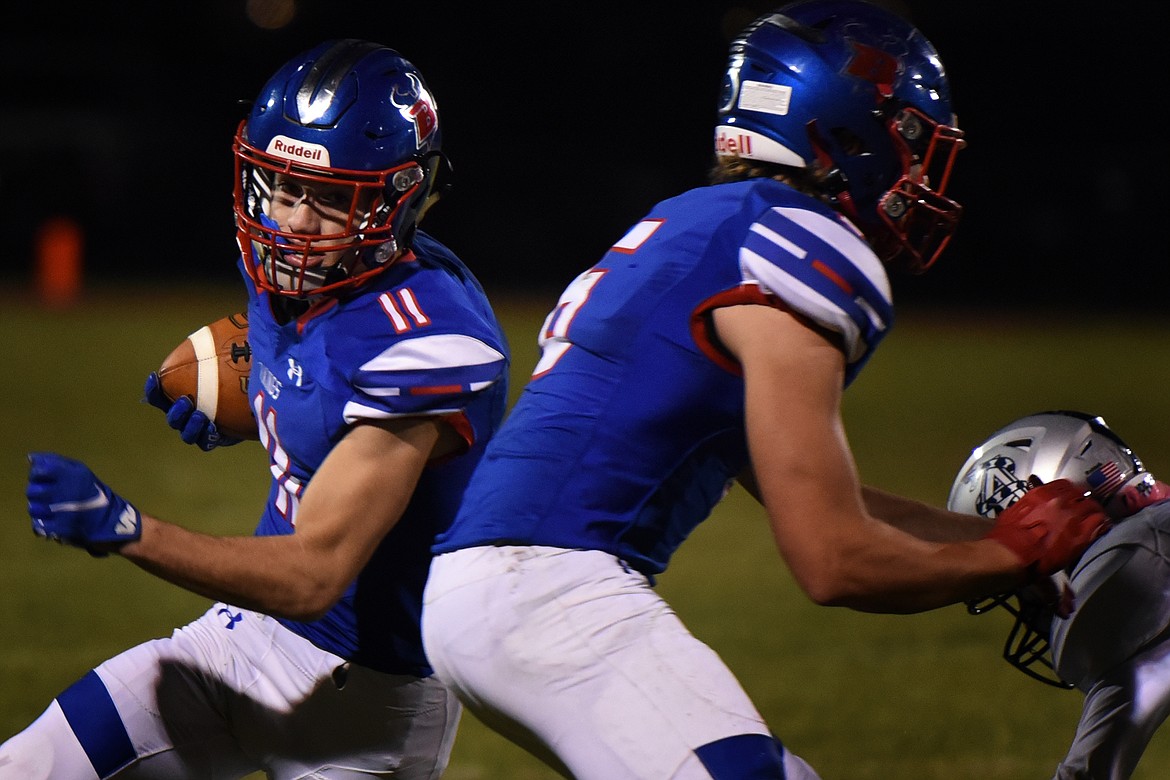 Viking running back George Bucklin (11) uses a block from teammate Nick Walker (6) to break free for a 46-yard touchdown run in the second quarter against Anaconda in Bigfork Friday. (Jeremy Weber/Bigfork Eagle)
