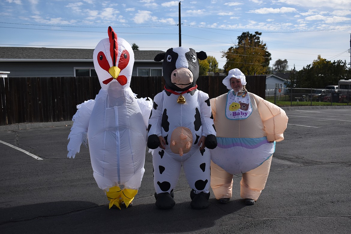 From the left, Haley Larsen, Karlee Larsen and Riley Larsen pose for a photo Saturday after walking around Moses Lake in their blow-up suits. The Herald spotted the three sharing a little levity walking along West Valley Road.