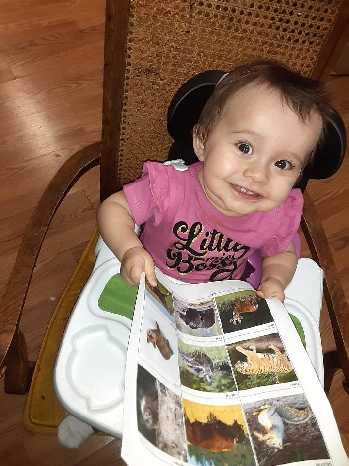 Gabby Sepulveda, 10 months, demonstrates the Parents as Teachers philosophy that it's never too early to begin learning to read. The PHD program works with families to prepare children for early school success.