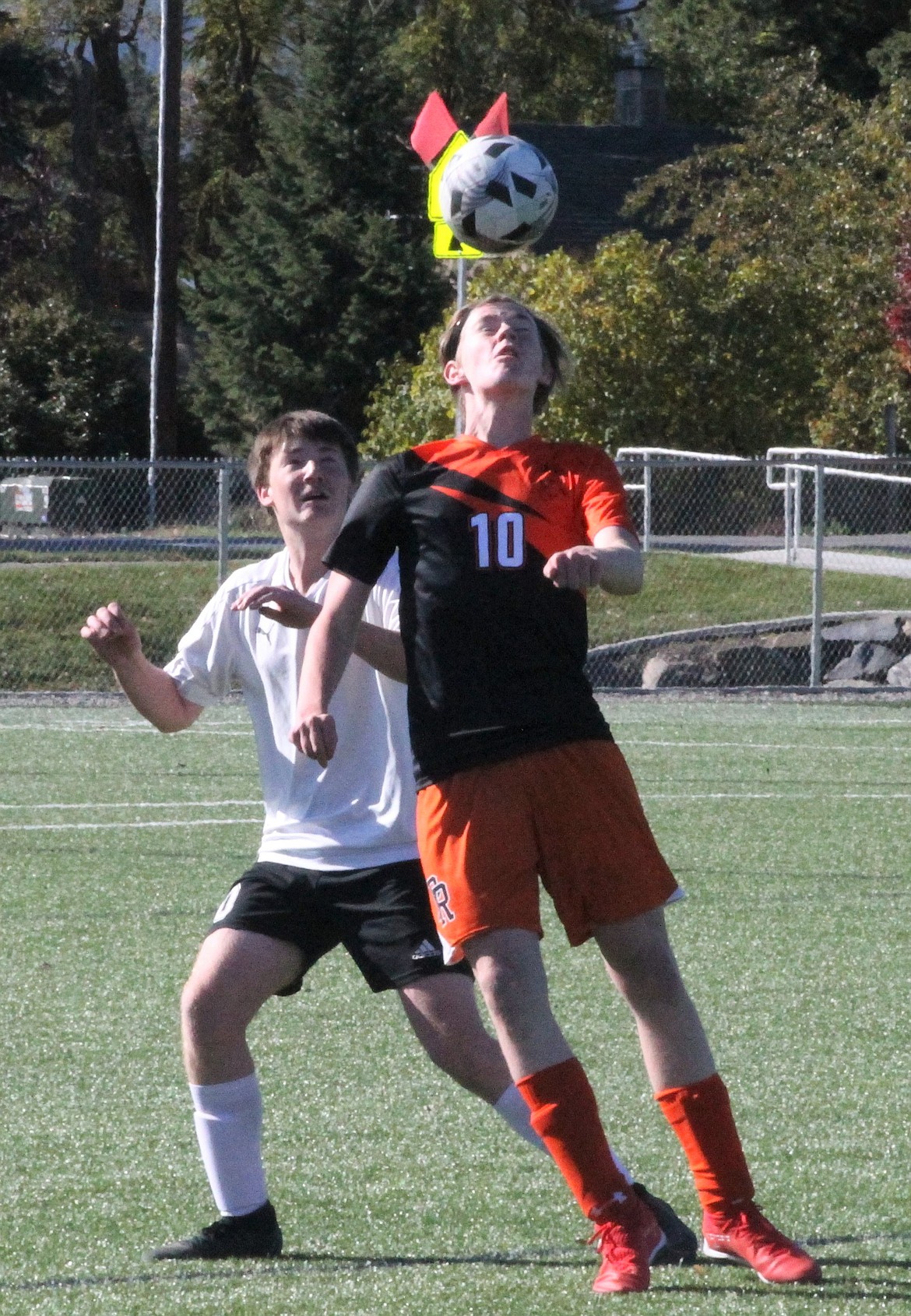 Priest River's Shane Gamber tries to settle a high-bouncing ball with a St. Maries defender nearby during Monday's match.