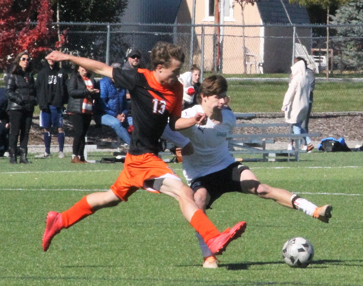 Erik Deem of Priest River and Lance Hamblin of St. Maries vie for the ball during Monday's match.