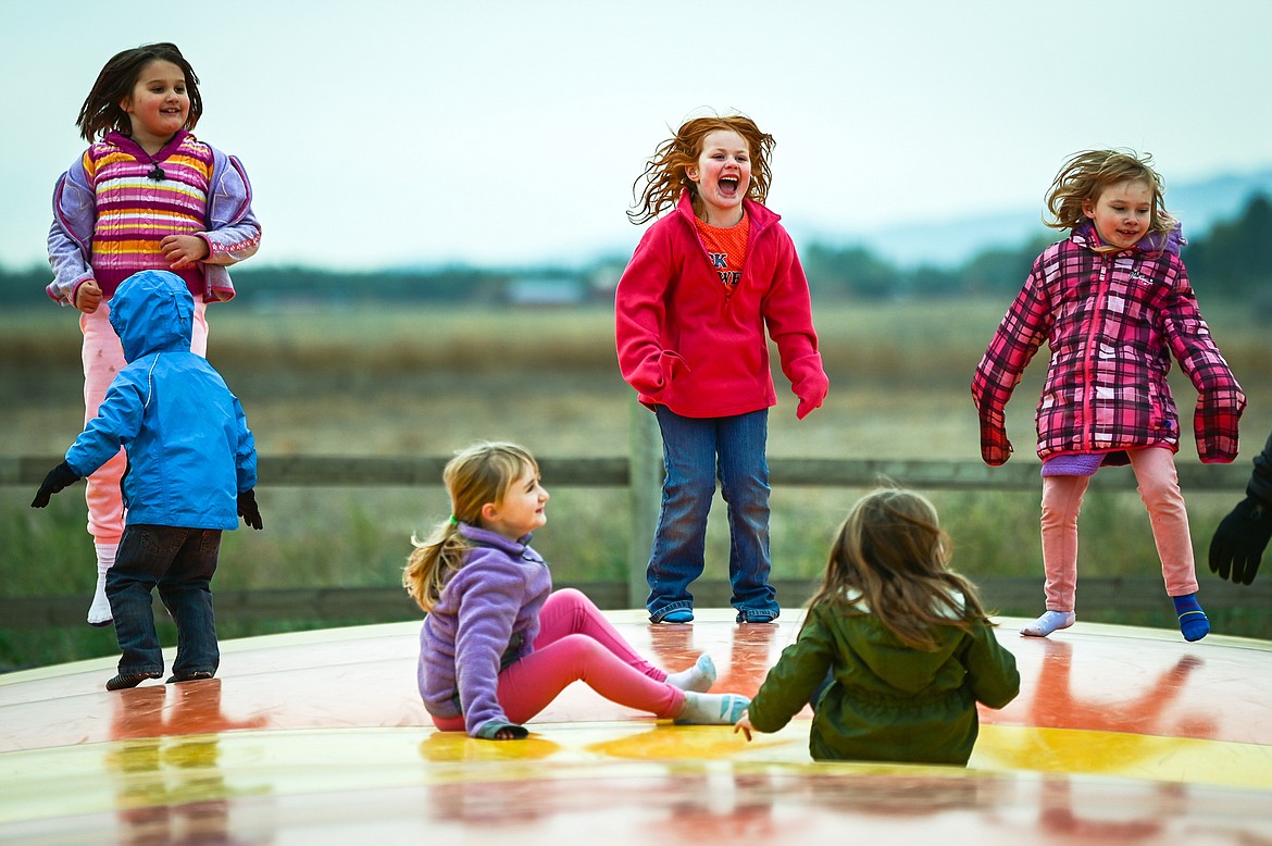 Kids bounce around on one of the giant jumping pillows at Sweet Pickin's Pumpkin Patch in Kalispell on Wednesday, Oct. 13. (Casey Kreider/Daily Inter Lake)