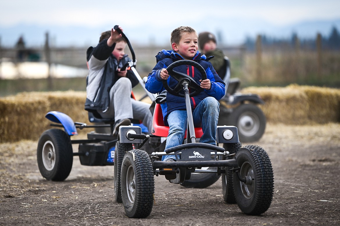 Kids ride around on the pedal cart track at Sweet Pickin's Pumpkin Patch in Kalispell on Wednesday, Oct. 13. (Casey Kreider/Daily Inter Lake)