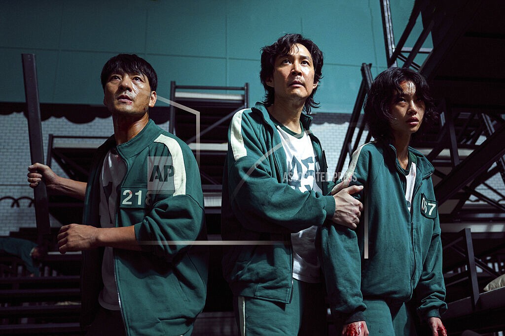 This undated photo released by Netflix shows South Korean cast members, from left, Park Hae-soo, Lee Jung-jae and Jung Ho-yeon in a scene from "Squid Game." Squid Game, a globally popular South Korea-produced Netflix show that depicts hundreds of financially distressed characters competing in deadly children’s games for a chance to escape severe debt, has struck a raw nerve at home, where there’s growing discontent over soaring household debt, decaying job markets and worsening income inequality. (Youngkyu Park/Netflix via AP)
