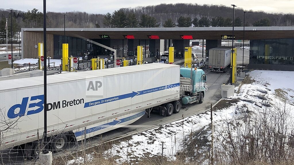 In this Wednesday, March 18, 2020 file photo, truck traffic from Canada waits to cross the border into the United States in Derby Line Vt. The U.S. will reopen its land borders to nonessential travel next month, ending a 19-month freeze due to the COVID-19 pandemic as the country moves to require all international visitors to be vaccinated against the coronavirus. The new rules, to be announced Wednesday, Oct. 13, 2021 will allow fully vaccinated foreign nationals to enter the U.S. regardless of the reason for travel (AP Photo/Wilson Ring, File)