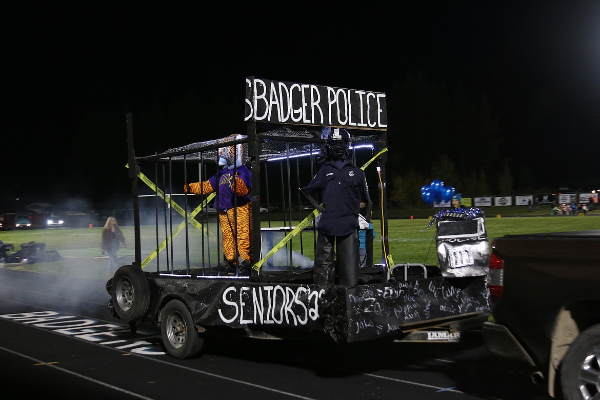 Badger Police themed float with Wildcat in cage.
