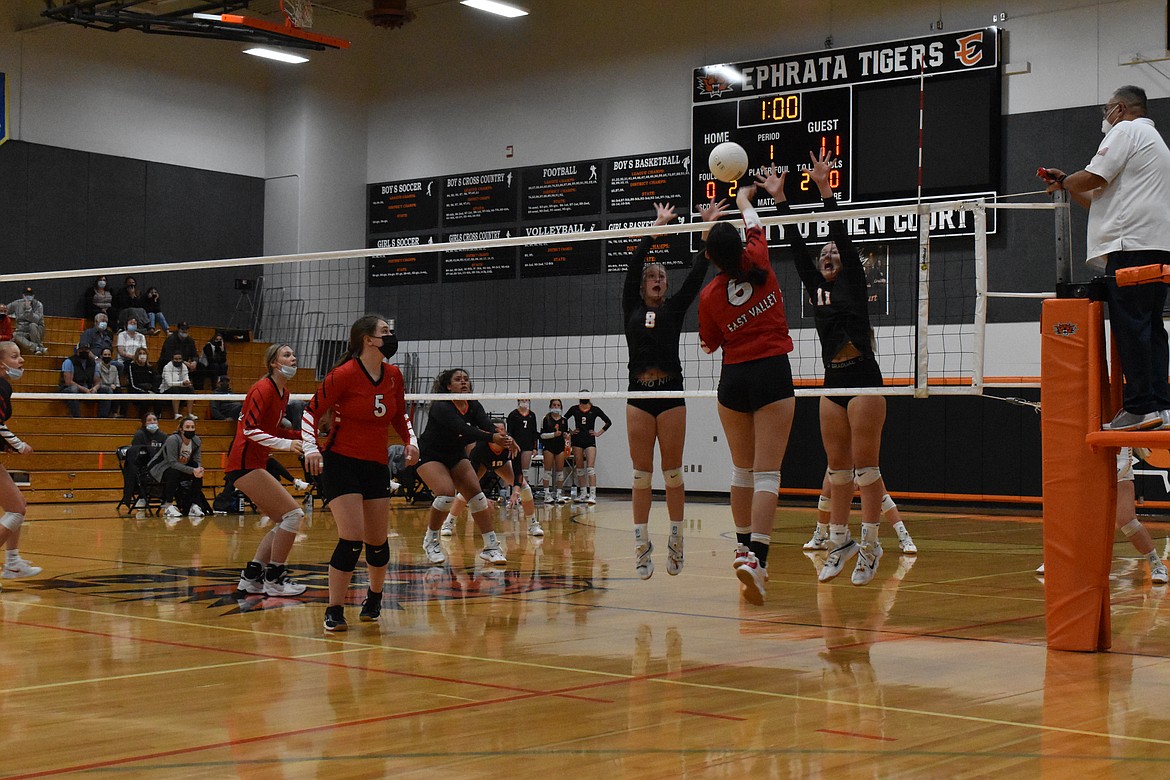 Kyndal Hines (8) and Addison Mills (11) jump to block the spike by an East Valley player.