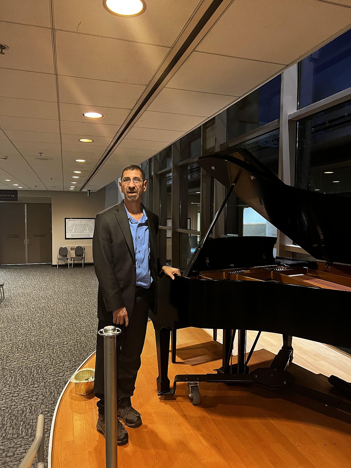 Alvarado poses in front of the baby grand piano at the Numerica Performing Arts Center in Wenatchee.