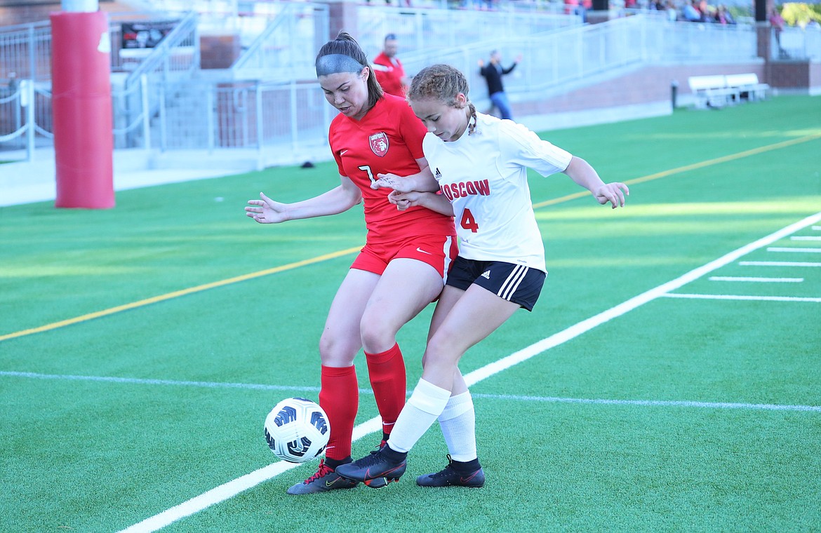 Sandpoint senior Sierrah VanGesen (left) fights off Moscow's Jessika Lassen for possession of the ball during a match on Sept. 23 at War Memorial Field.