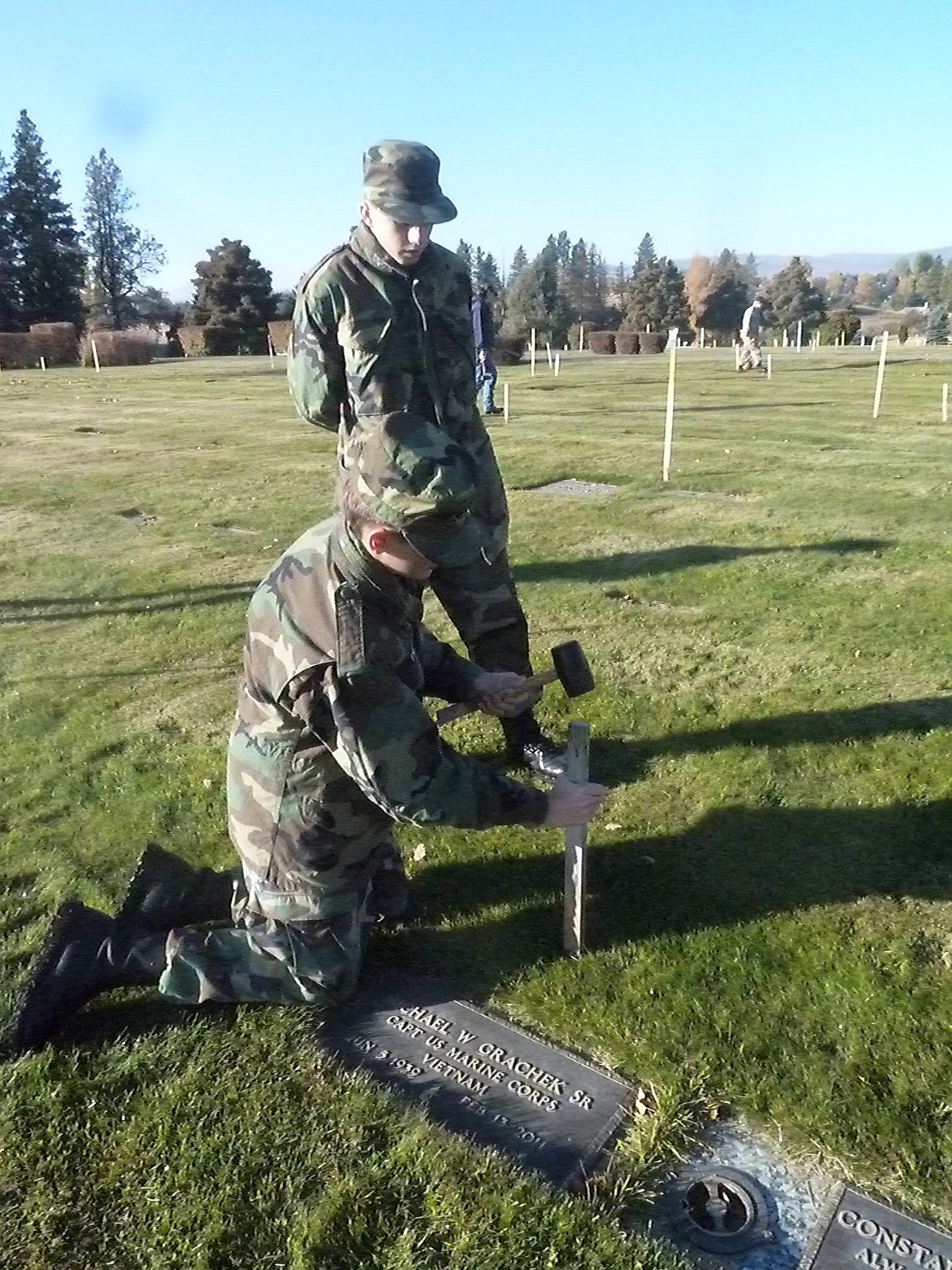 Civil Air Patrol Flathead Composite Squadron cadets place stakes on the graves of veterans in area cemeteries. The Squadron will lay wreaths on them in December.