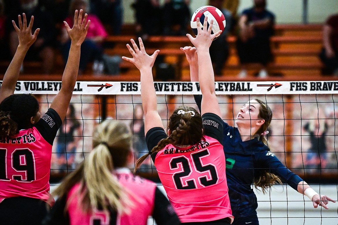 Glacier's Sidney Gulick (2) goes up for a kill against Flathead's Akilah Kubi (19) and Alliyah Stevens (25) at Flathead High School on Thursday, Oct. 14. (Casey Kreider/Daily Inter Lake)