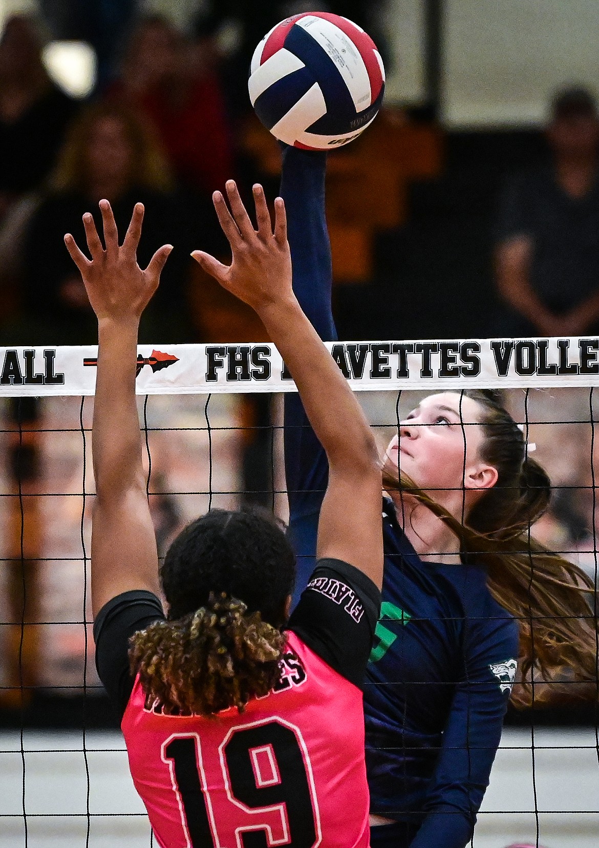 Glacier's Ella Farrell (15) looks for a kill against Flathead's Akilah Kubi (19) at Flathead High School on Thursday, Oct. 14. (Casey Kreider/Daily Inter Lake)