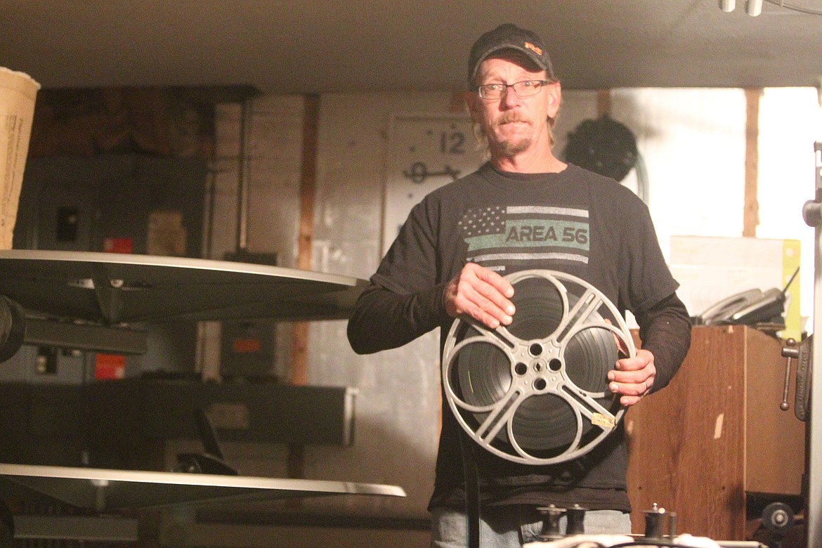 Josh Moore holds a reel of film in the projector room at the Lincoln Theatre. Thanks to community donations, Josh and Tina Moore were able to purchase a digital projector and spruce up the single screen cinema. (Will Langhorne/The Western News)