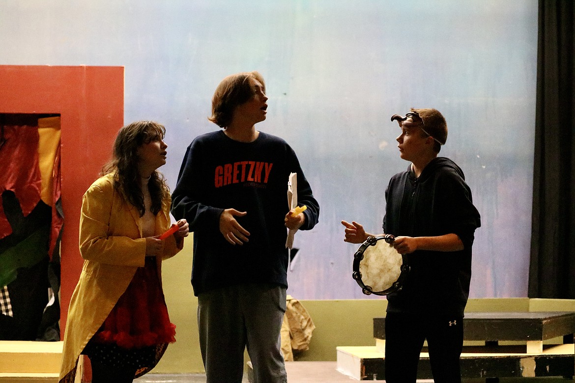 From left, Lake City High School senior Hannah Strickland, sophomore Luke Sharon, and sophomore Bradley Gillmore rehearse for "No Fish in the House." The play, inspired by 16th century Italian comedic theater, opens Thursday at the high school. HANNAH NEFF/Press