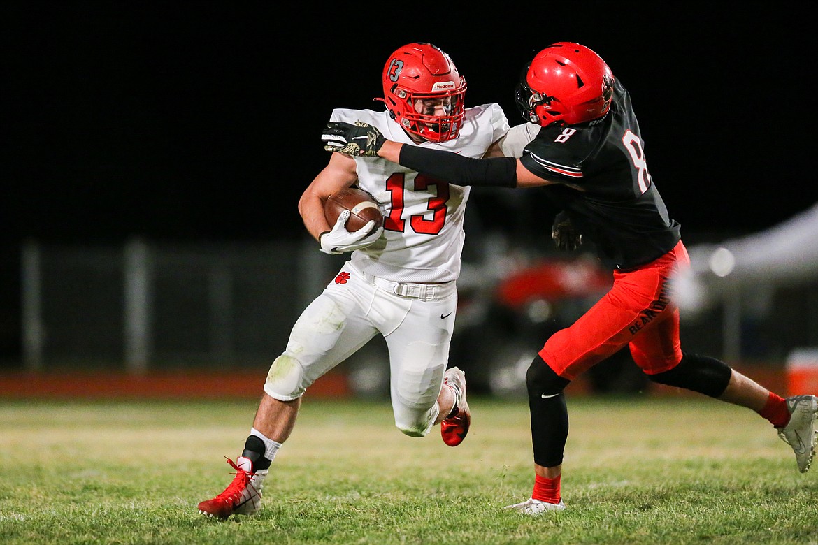 Running back Gerrit Cox stiff arms a Moscow defender during Friday's game.