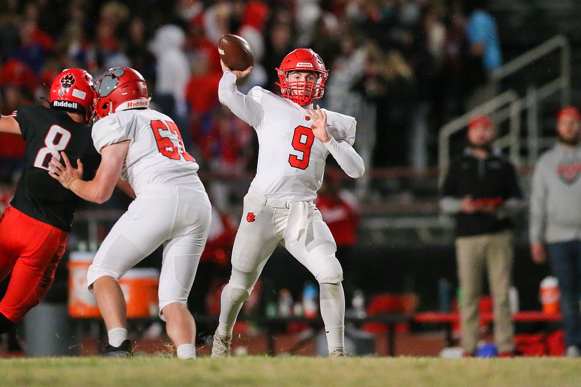 Quarterback Parker Pettit drops back to pass during Friday's game at Moscow.