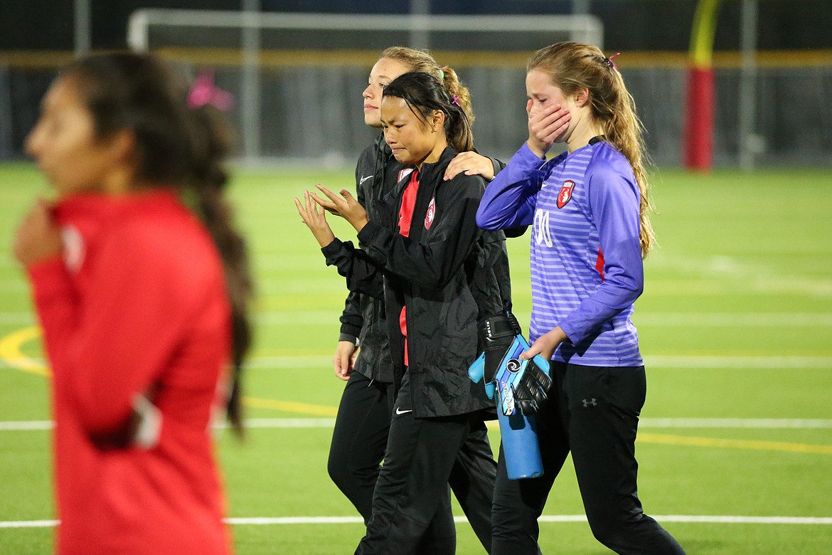 Sandpoint players cry after Thursday's heartbreaking loss to Moscow.