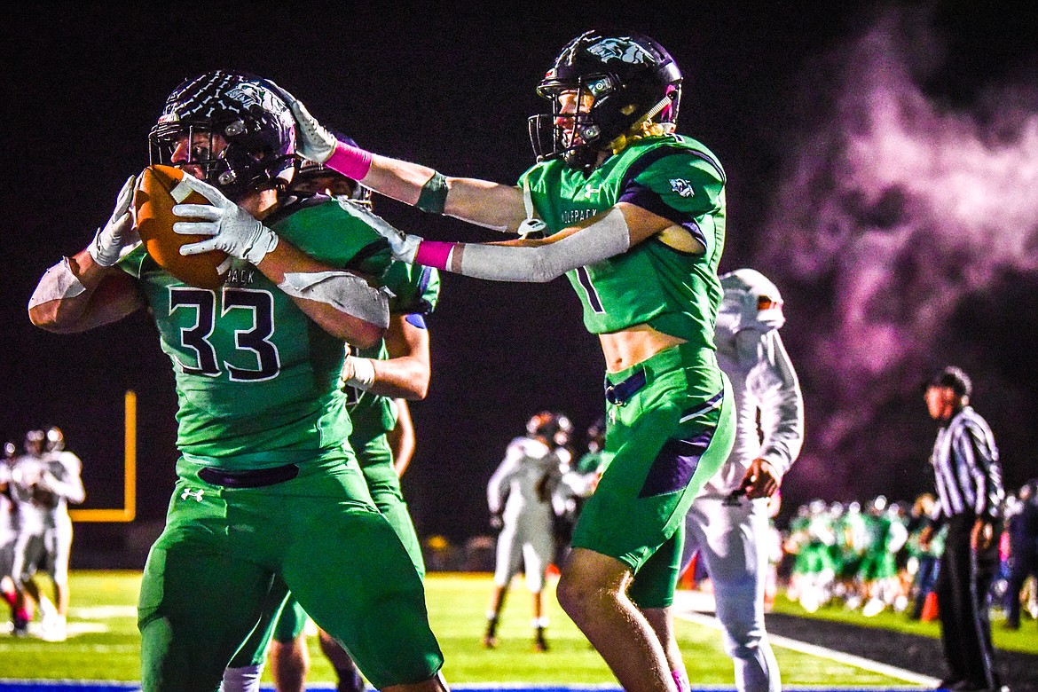 Glacier running back Jake Rendina (33) and wide receiver Tate Kauffman (1) celebrate in the end zone after a touchdown run by Rendina in the second quarter against Flathead at Legends Stadium on Friday, Oct. 15. (Casey Kreider/Daily Inter Lake)