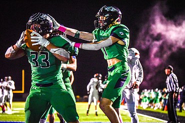 Glacier running back Jake Rendina (33) and wide receiver Tate Kauffman (1) celebrate in the end zone after a touchdown run by Rendina in the second quarter against Flathead at Legends Stadium on Friday, Oct. 15. (Casey Kreider/Daily Inter Lake)