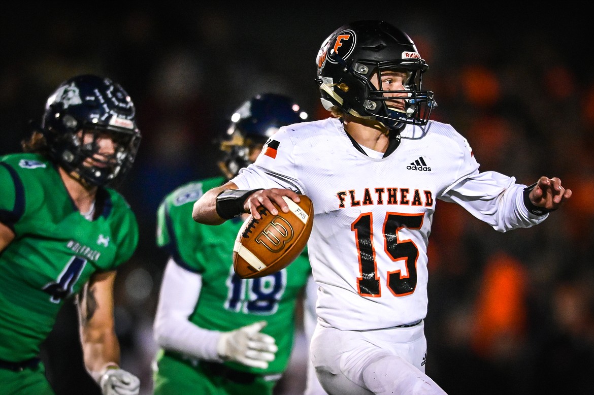 Flathead quarterback Haiden Bunyea (15) rolls out to pass in the second quarter against Glacier at Legends Stadium on Friday, Oct. 15. (Casey Kreider/Daily Inter Lake)