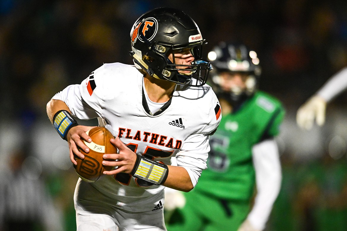 Flathead quarterback Haiden Bunyea (15) rolls out to pass in the first quarter against Glacier at Legends Stadium on Friday, Oct. 15. (Casey Kreider/Daily Inter Lake)