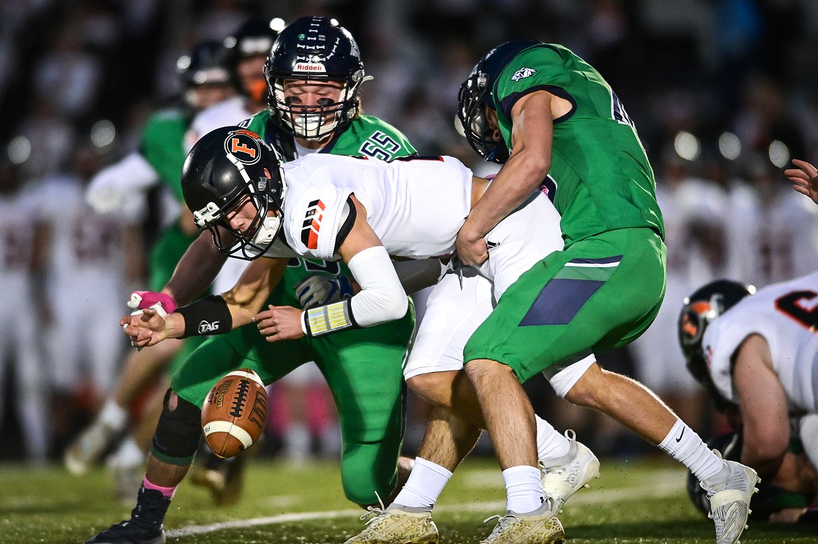 Glacier defenders Erik Junk (55) and Royce Conklin (46) cause a fumble by Flathead quarterback Jackson Walker (2) in the first quarter at Legends Stadium on Friday, Oct. 15. (Casey Kreider/Daily Inter Lake)