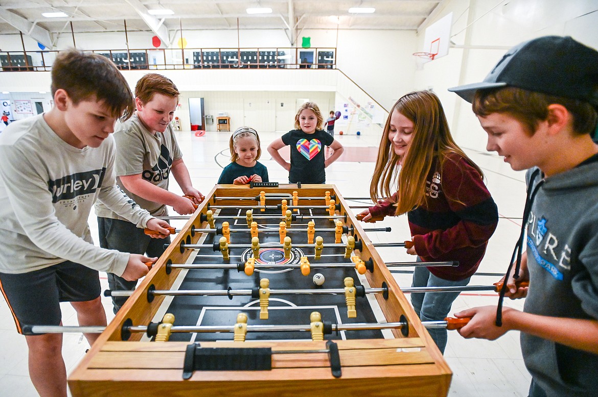 Kids play a game of foosball at the Boys & Girls Clubs of Glacier Country Evergreen Clubhouse ribbon cutting event on Thursday, Oct. 14. (Casey Kreider/Daily Inter Lake)