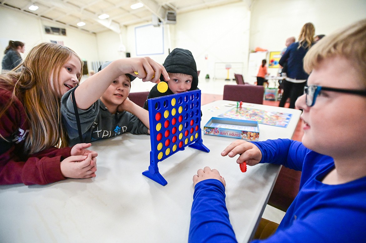 Kids play a game of Connect 4 at the Boys & Girls Clubs of Glacier Country Evergreen Clubhouse ribbon cutting event on Thursday, Oct. 14. (Casey Kreider/Daily Inter Lake)