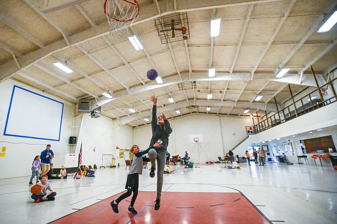 Kids and staff shoot basketball at the Boys & Girls Clubs of Glacier Country Evergreen Clubhouse ribbon cutting event on Thursday, Oct. 14. (Casey Kreider/Daily Inter Lake)