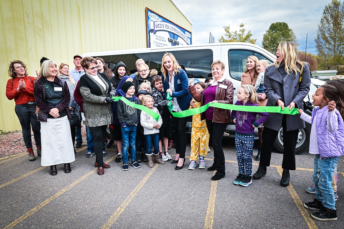 Members of the Evergreen Chamber of Commerce and the Boys & Girls Clubs of Glacier Country cut a ribbon outside the Evergreen Clubhouse on Thursday, Oct. 14. (Casey Kreider/Daily Inter Lake)