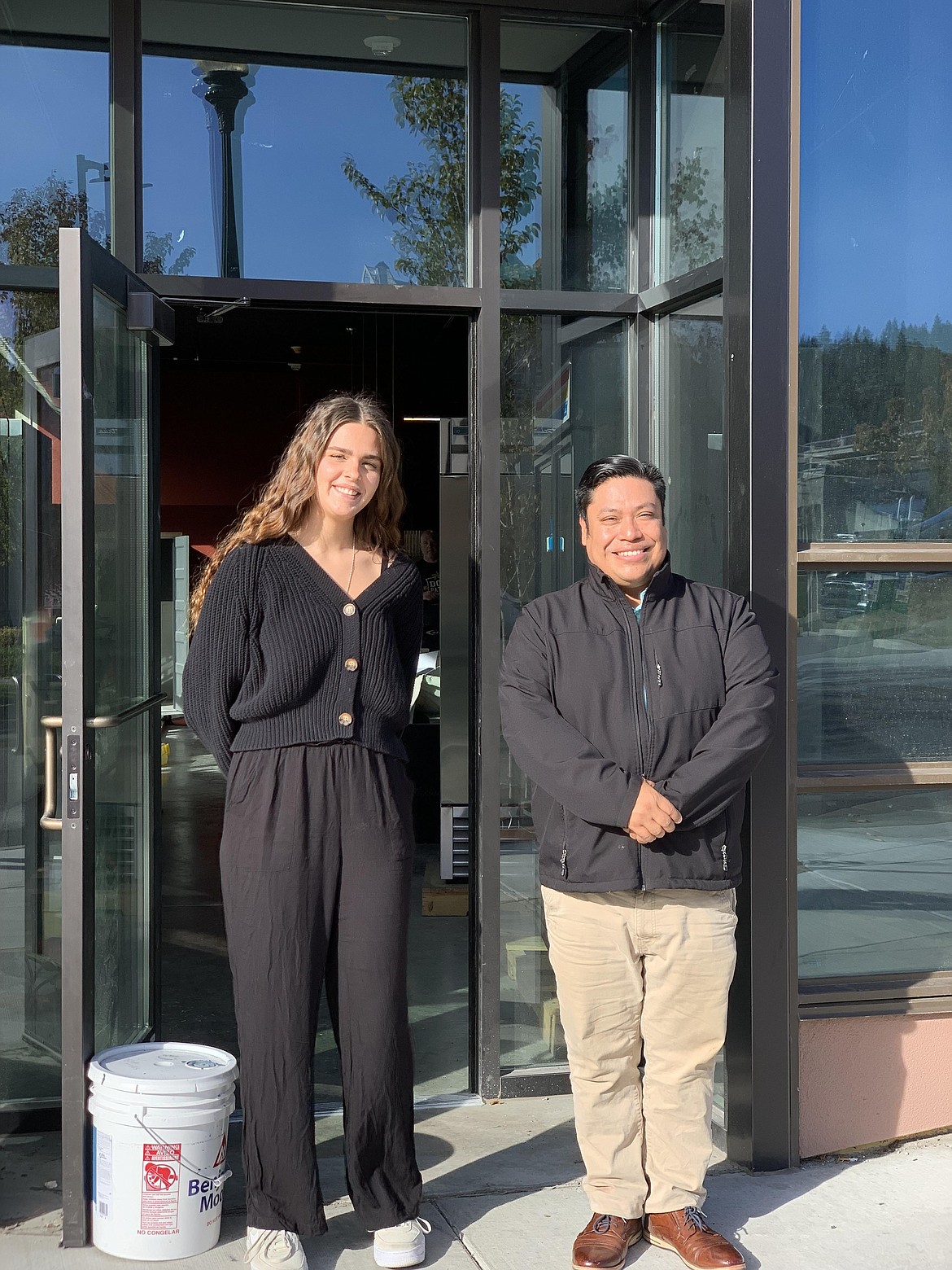 Lexi Zenk and general manager Brent Reuer stand outside the Point Market.