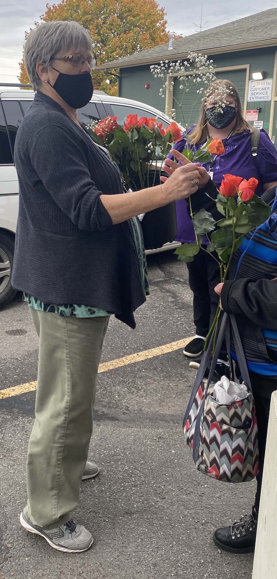 TESH teacher Kathie Gilman handed roses out Friday, as clients prepared to go home for the weekend.