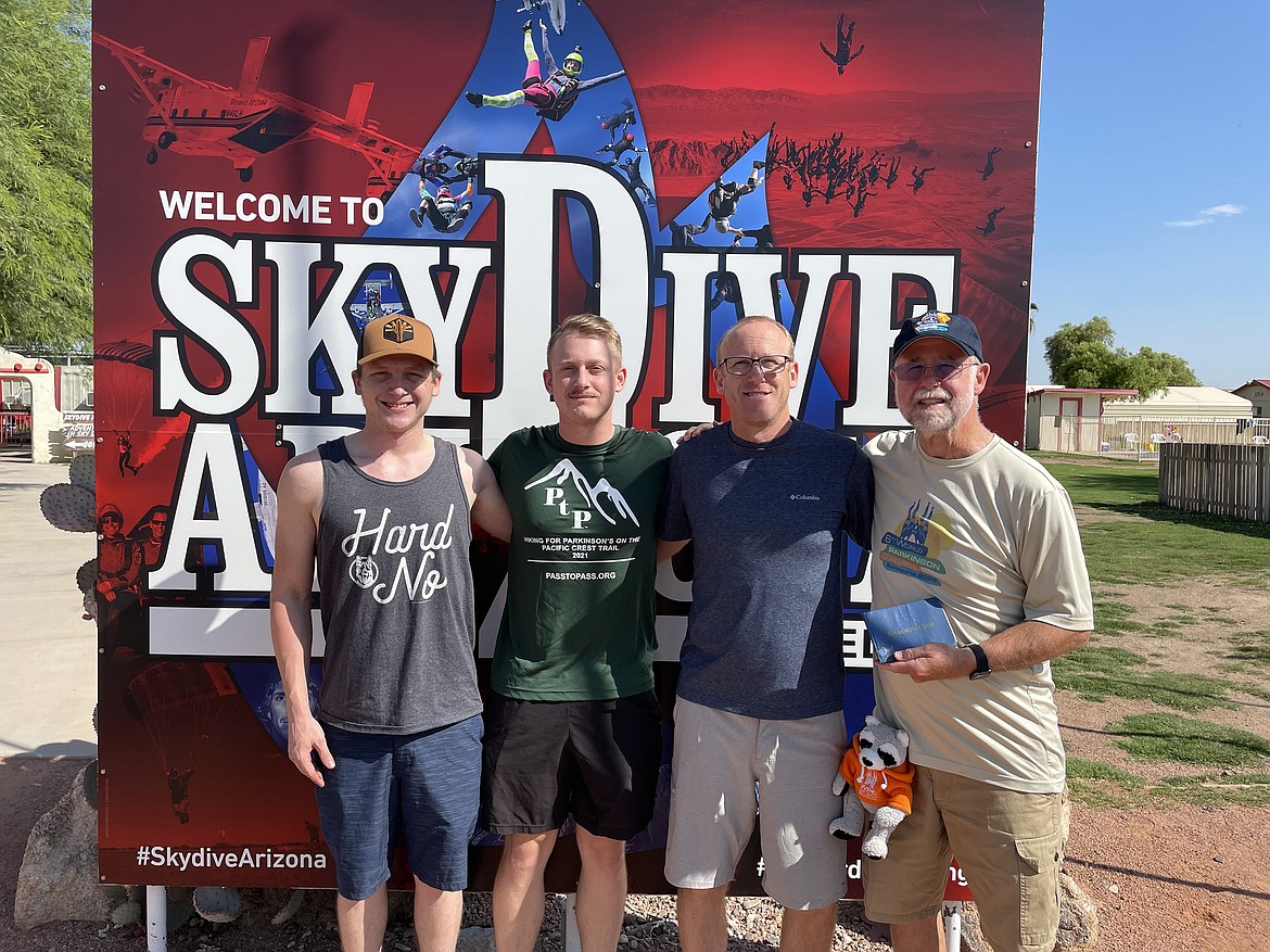 A.C. Woolnough, far right, is pictured with his son and his grandsons at the jump site in Arizona. Hanging from a carabiner attached to his belt is his Parkinson's mascot, Parky, who also made the jump.