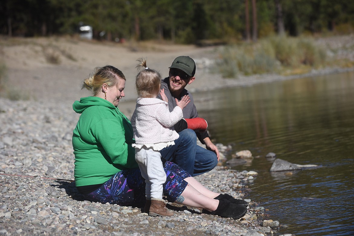 A Northwest Montana family practices their rock skipping skills last Saturday on the Clark Fork River in Sanders County. Warm temperatures saw many campers and anglers enjoying time outdoors last weekend. (Scott Shindledecker/Valley Press)