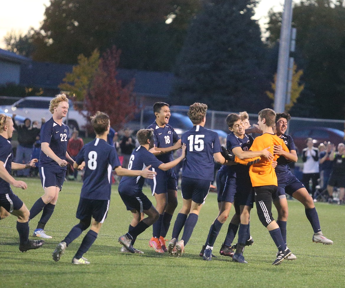 JASON ELLIOTT/Press
Coeur d'Alene Charter midfielder Brandon Chavez (10) hugs goalkeeper Miles Taylor after his save in the fourth round of a penalty kick shootout clinched the 3A District 1-2 boys soccer championship on Saturday at The Fields at Real Life in Post Falls.
