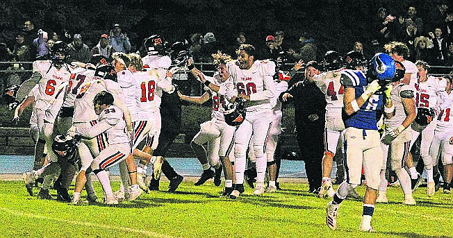 MARK NELKE/Press 
Post Falls players celebrate after the Trojans beat Coeur d'Alene 32-27 on Friday night at Coeur d'Alene, Post Falls' first win over the Vikings since 2015.