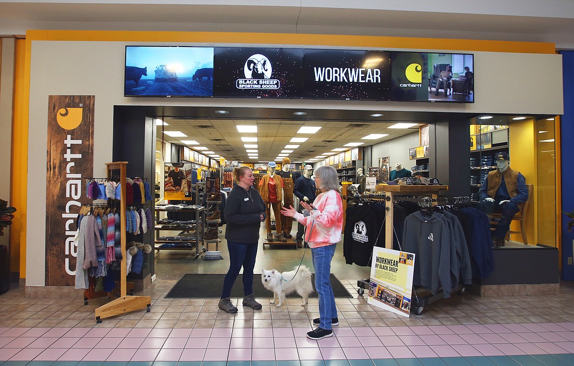 Marlene Brannan walks her American Eskimo, Pandora, around the mall Friday and stops to chat with Jeni Brooks, sales lead at Work Wear by Black Sheep.