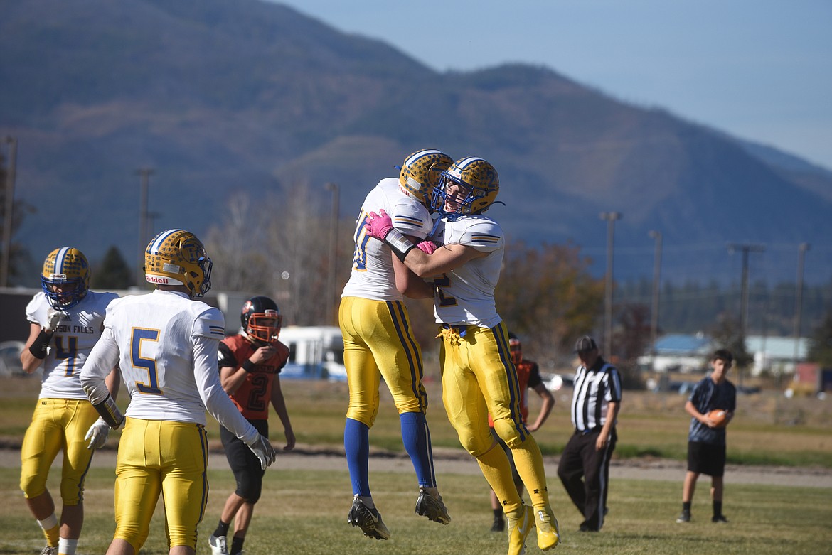 Thompson Falls running back Ryan Bucher celebrates a TD run with teammate Erik Strom in last Saturday’s 61-6 win over Plains. (Scott Shindledecker/Valley Press)